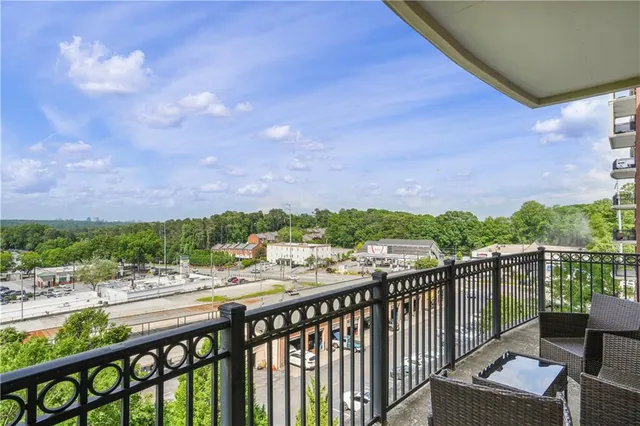 a view of a balcony with wooden floor and city view