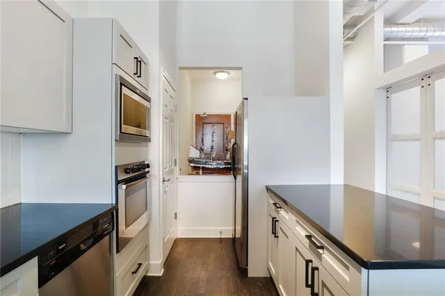 a kitchen with stainless steel appliances a sink stove and refrigerator