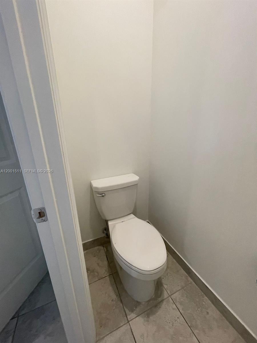 4451 Southwest 159th Path Miami, FL 33185 - Photo 14 of 24 a white toilet sitting next to a sink