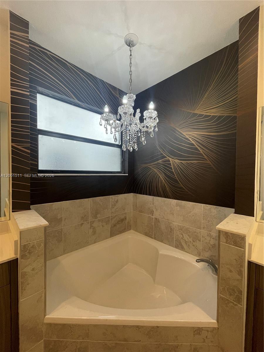 4451 Southwest 159th Path Miami, FL 33185 - Photo 21 of 24 a bath tub sitting in a bathroom next to a window