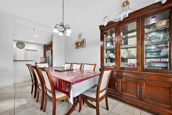 a dining room with a wooden table and chairs