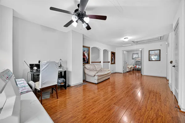 a living room with furniture and a wooden floor