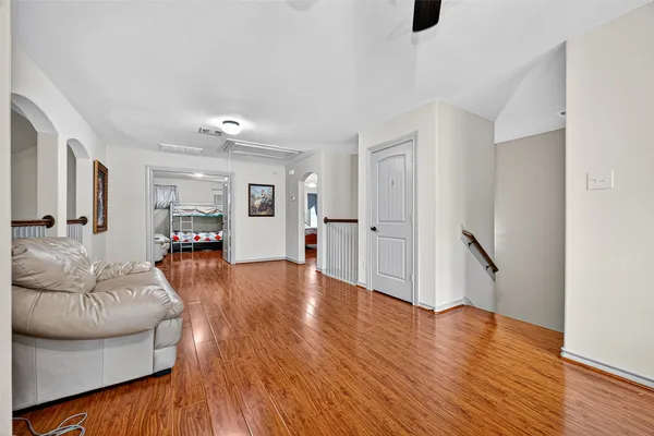 a living room with furniture and a wooden floor