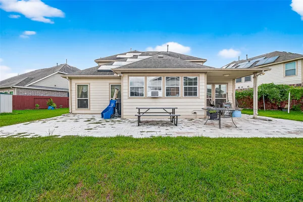 a front view of a house with a yard and dining space