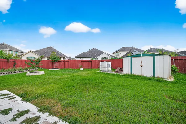 a view of a house with a yard and trampoline