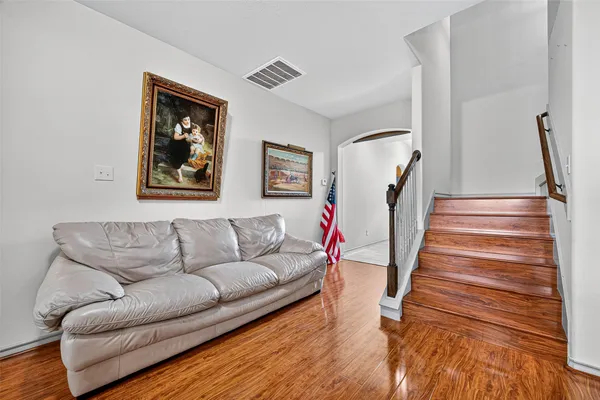 a living room with furniture and a stairs
