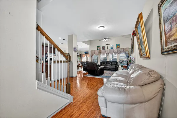 a living room with furniture fireplace and a large window