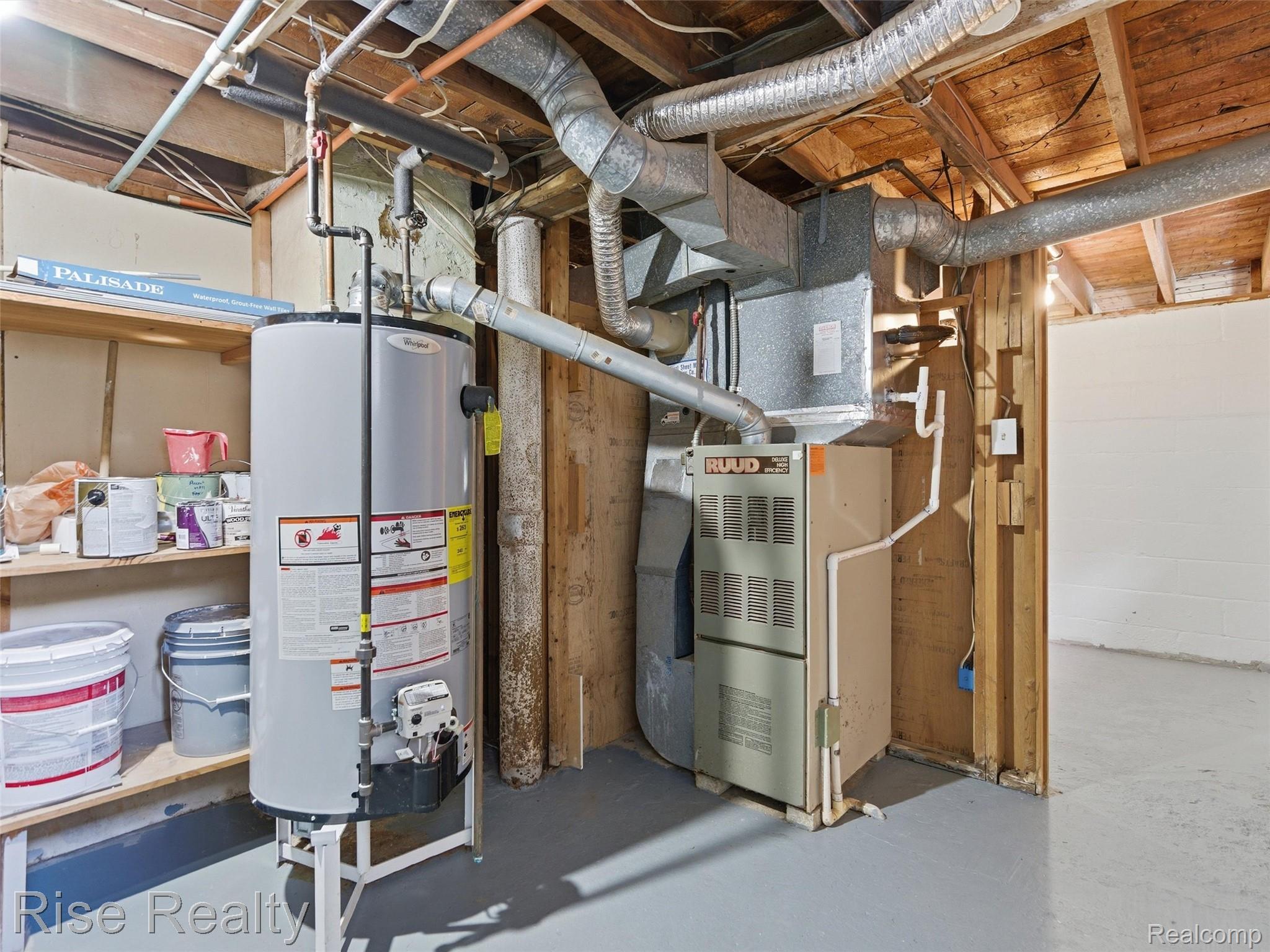 2449 North Genesee Road Burton, MI 48509 - Photo 31 of 40 Utility area featuring a water heater and furnace with exposed ductwork, timber ceiling joists, and painted concrete flooring