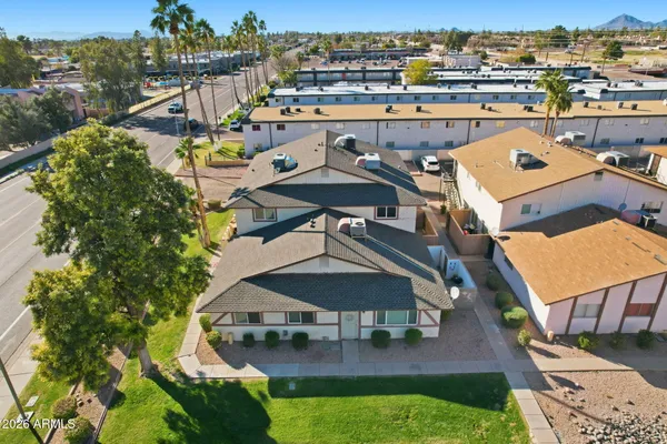 an aerial view of a house with swimming pool a yard and lake view