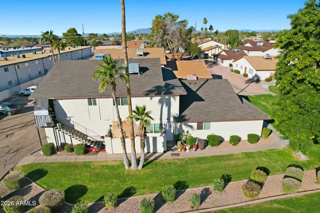an aerial view of a house having patio and a garden