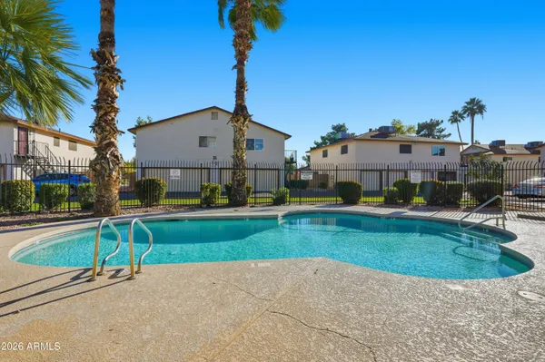 a view of a house with a swimming pool and a yard