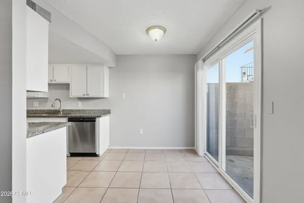 a kitchen with stainless steel appliances granite countertop a refrigerator sink and cabinets