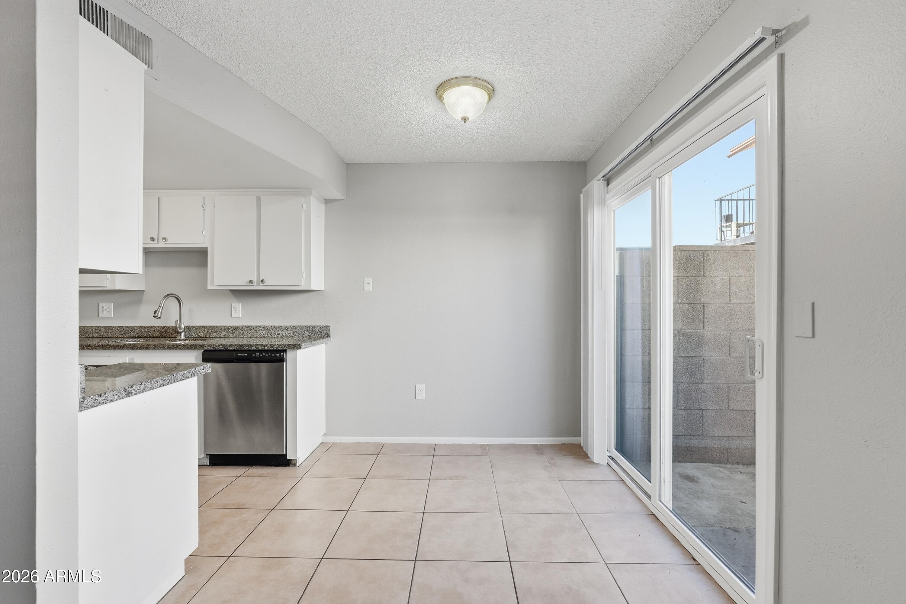 860 East Brown Road, Unit 29 Mesa, AZ 85203 - Photo 23 of 54 a kitchen with stainless steel appliances granite countertop a refrigerator sink and cabinets