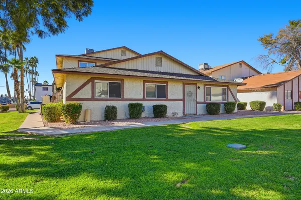 a front view of a house with a yard and porch