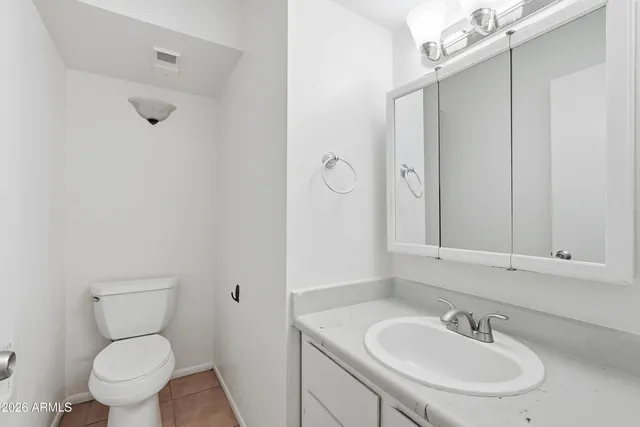 a bathroom with a sink a toilet and mirror