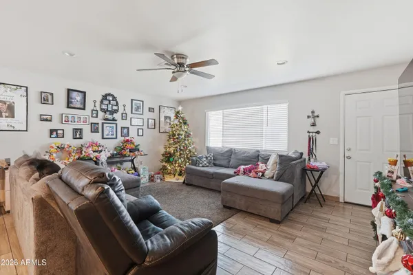 a living room with furniture kitchen view and a window