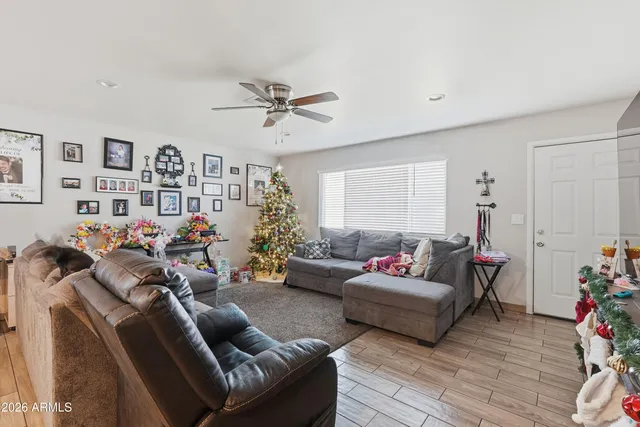 a living room with furniture kitchen view and a window
