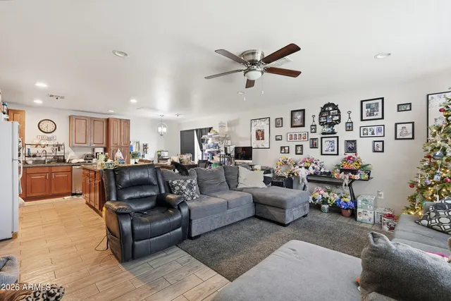 a kitchen with stainless steel appliances granite countertop a stove top oven a sink dishwasher a dining table and chairs with wooden floor