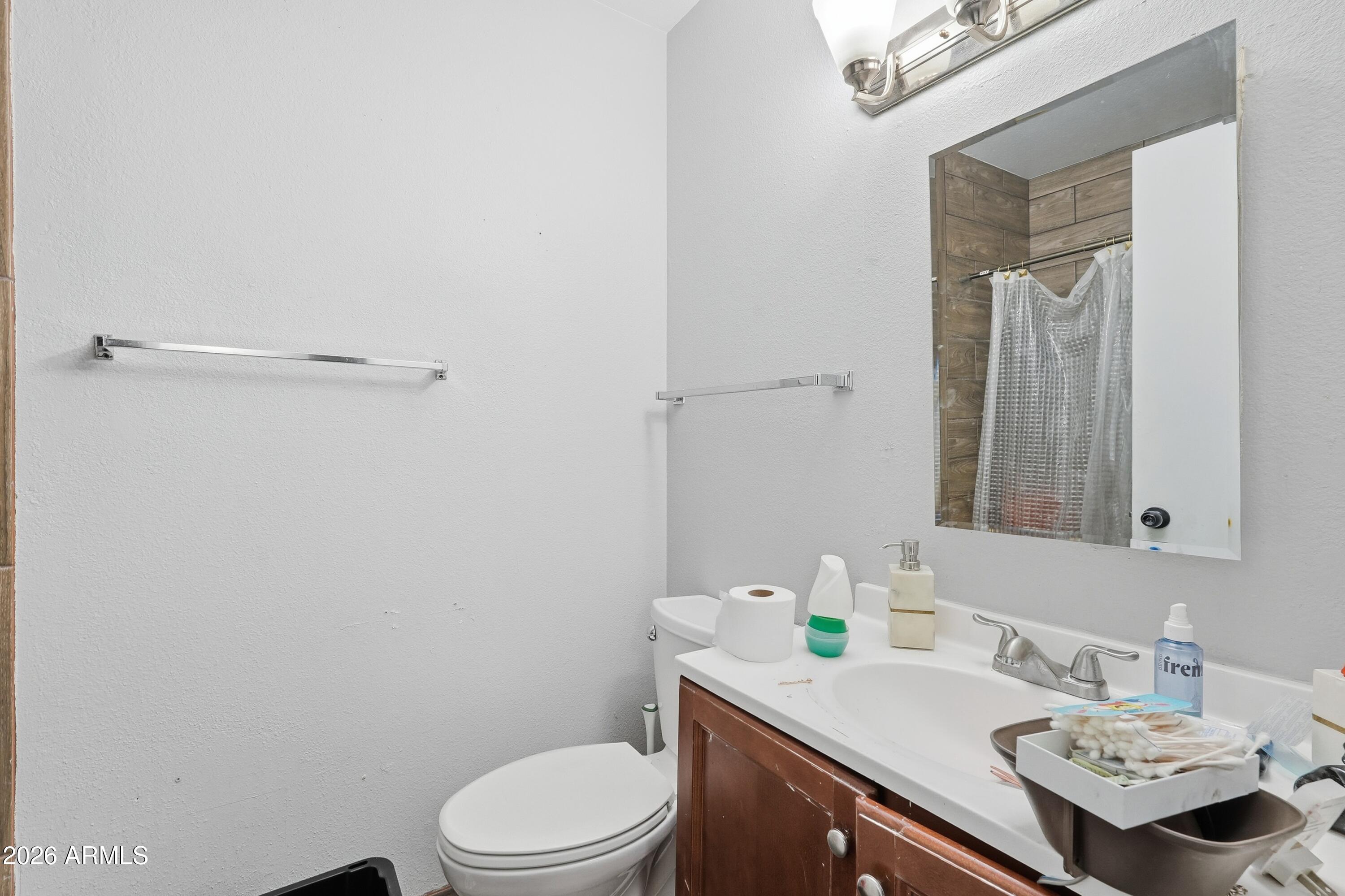 860 East Brown Road, Unit 29 Mesa, AZ 85203 - Photo 49 of 54 a bathroom with a sink toilet and mirror