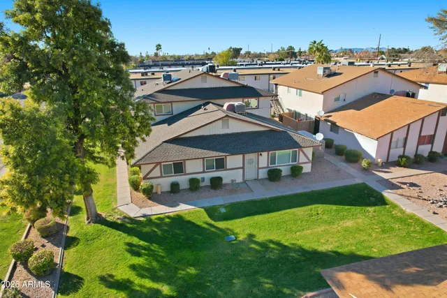 an aerial view of a house with swimming pool garden and patio