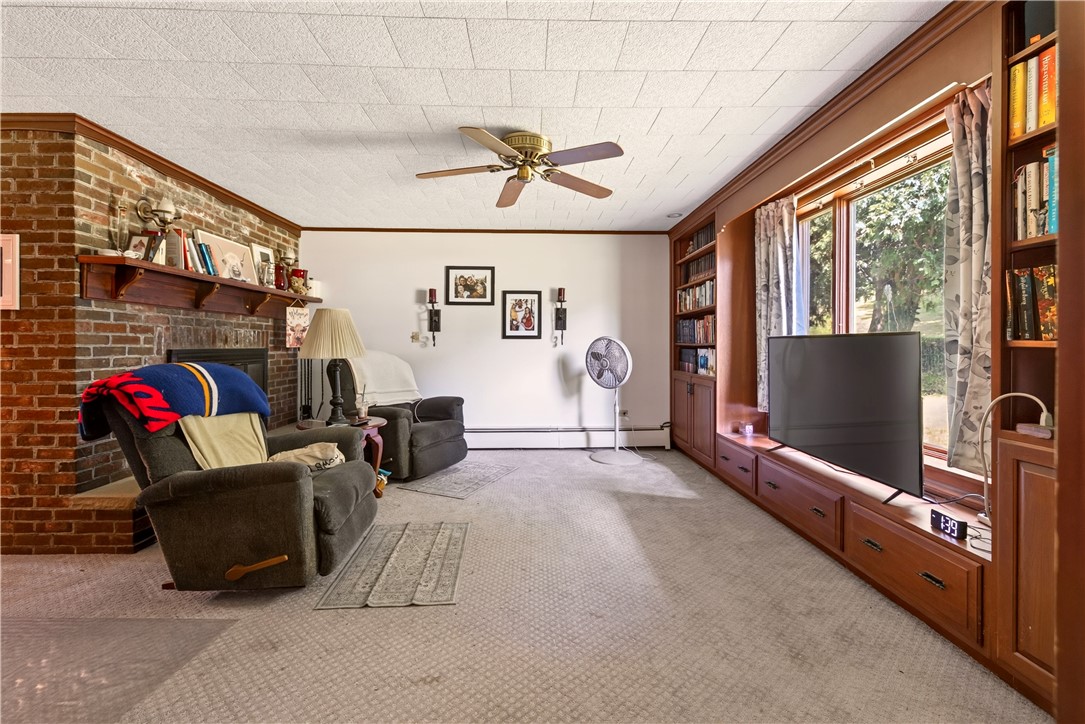 7780 Cold Springs Road Bath, NY 14810 - Photo 13 of 50 Rich wood built-ins and a classic brick fireplace anchor this cozy living space.