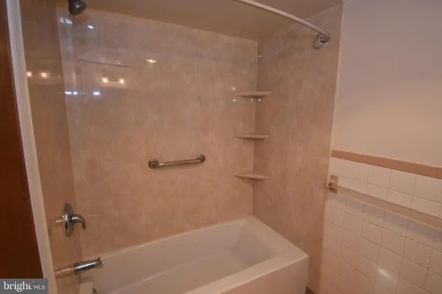 a bathroom with a shower and a bath tub