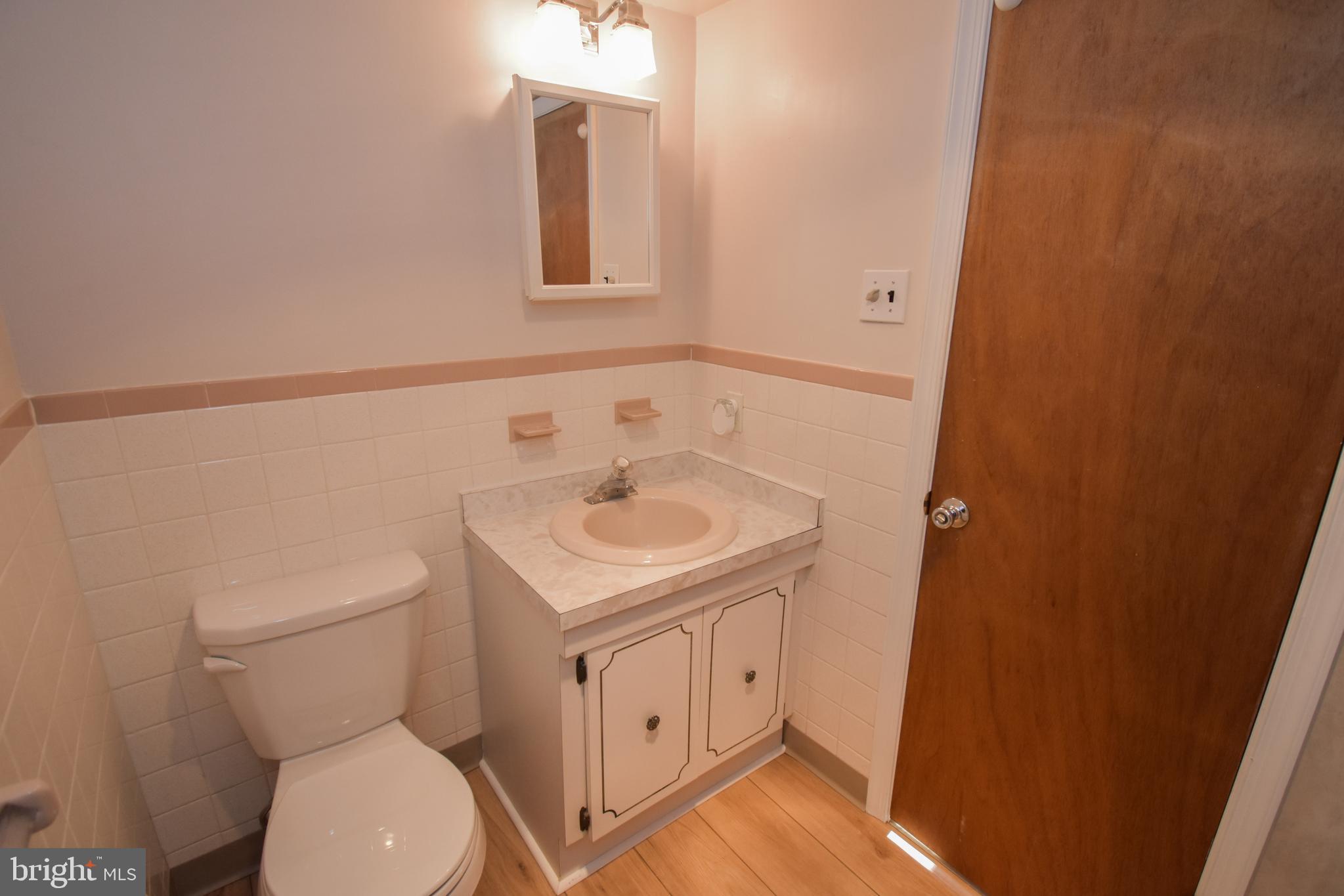 6-1 Aspen Way Doylestown, PA 18901 - Photo 13 of 19 a bathroom with a toilet sink and mirror