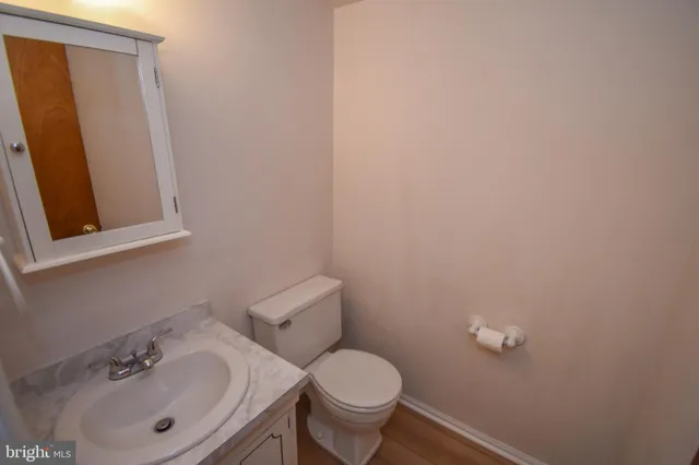 a bathroom with a sink mirror and toilet