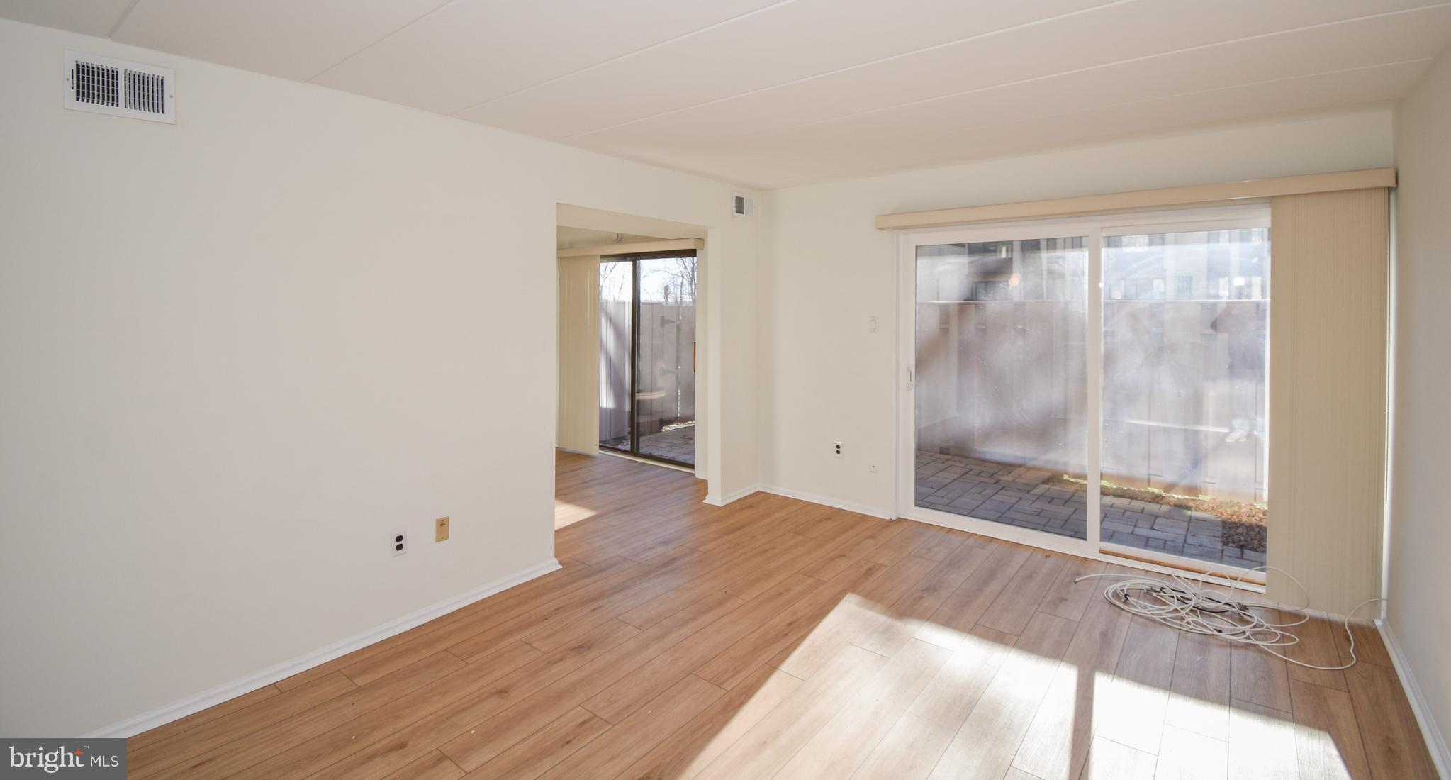 6-1 Aspen Way Doylestown, PA 18901 - Photo 6 of 19 a view of an empty room with wooden floor and a window