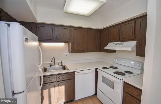 a kitchen with a sink a stove and refrigerator
