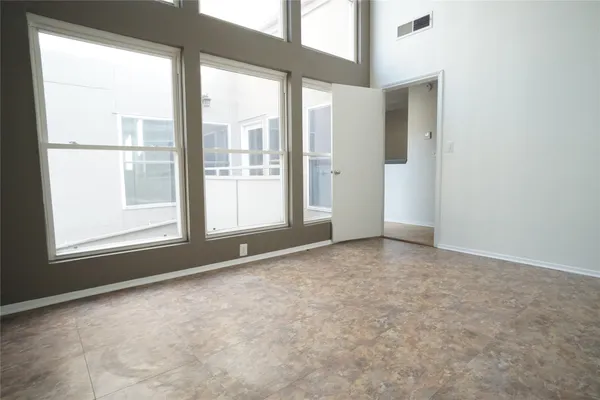 a kitchen with granite countertop white cabinets and black appliances