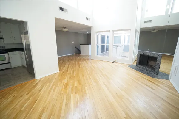 a kitchen with granite countertop white cabinets and stainless steel appliances