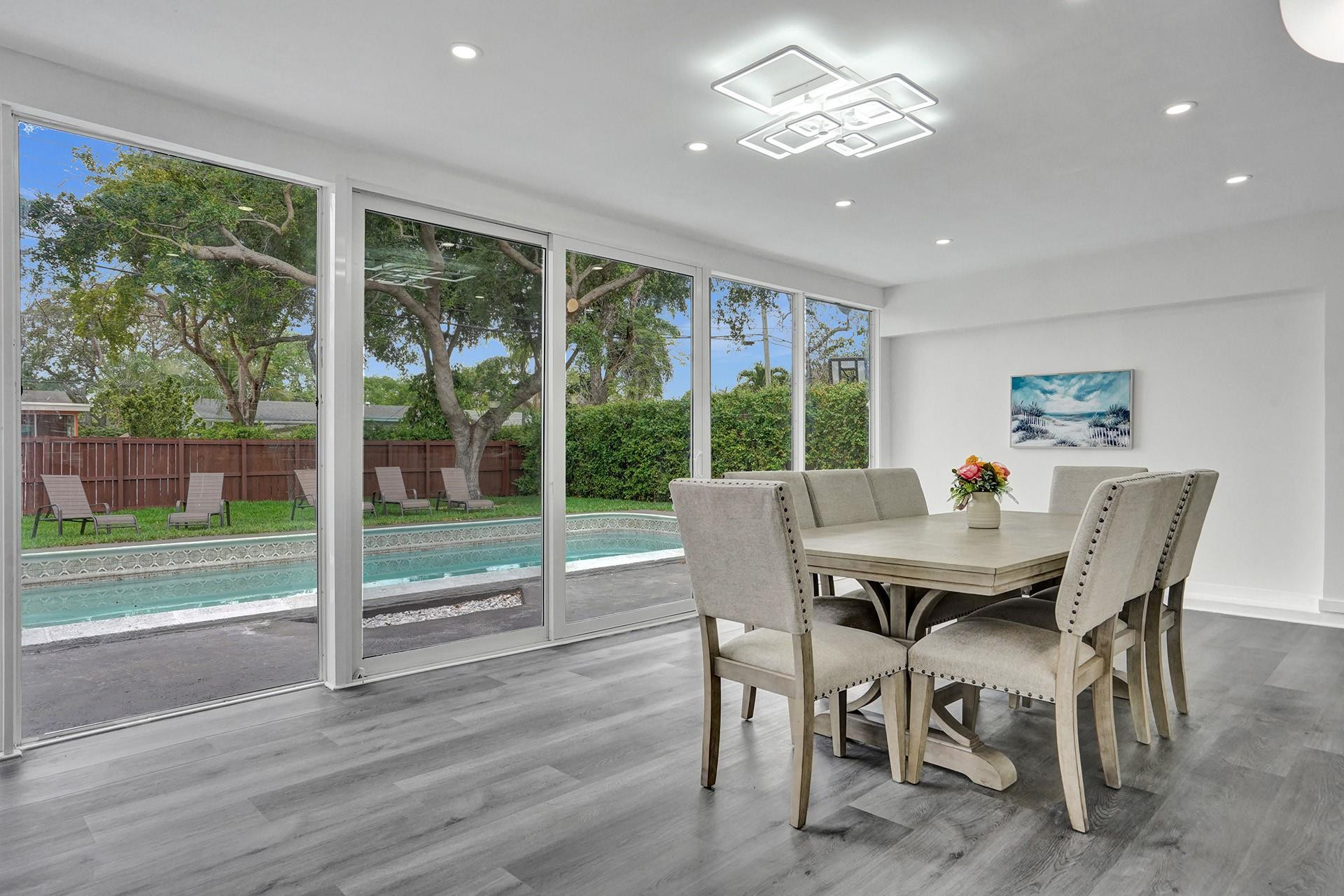 2114 North 42nd Avenue Hollywood, FL 33021 - Photo 4 of 24 a view of a dining room with furniture large windows and wooden floor