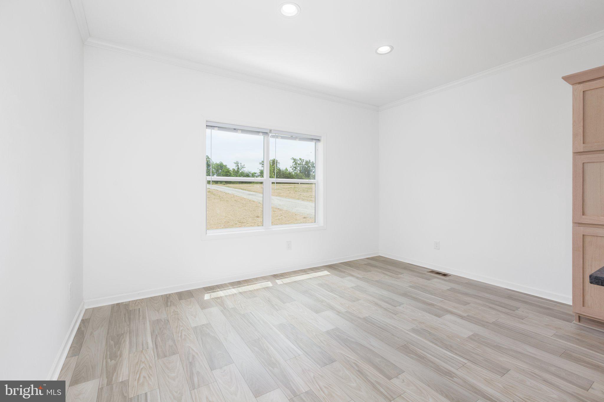 967 Levi Road Green Bay, VA 23942 - Photo 13 of 39 an empty room with wooden floor and window