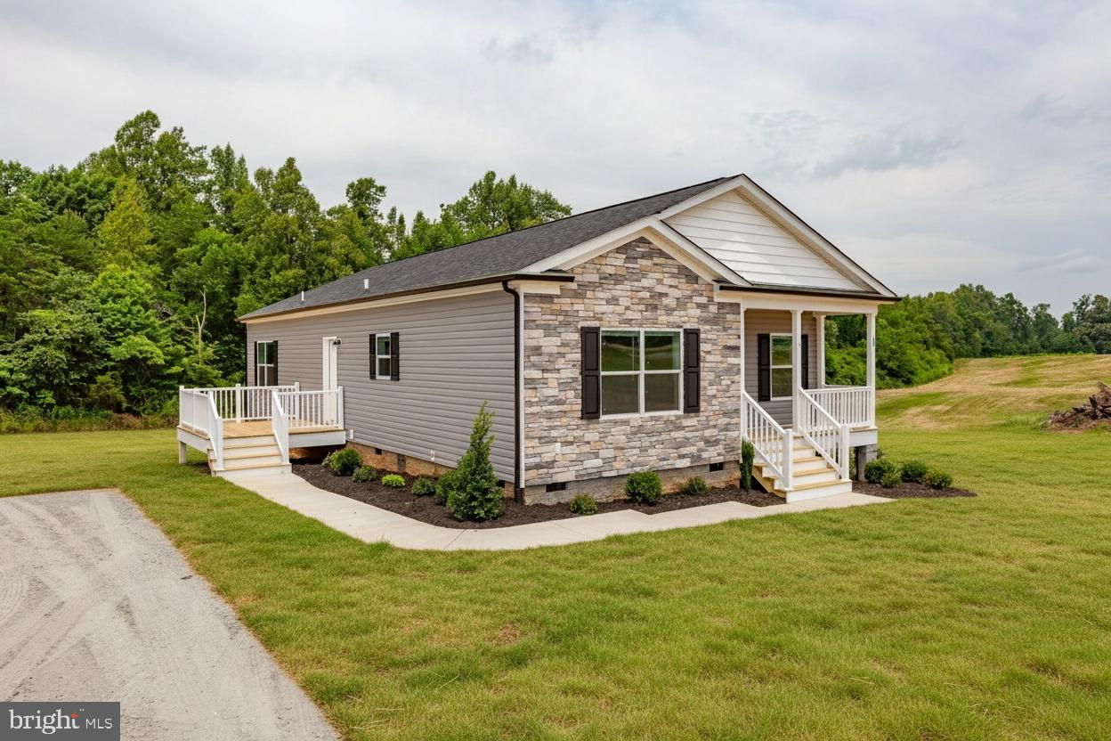 967 Levi Road Green Bay, VA 23942 - Photo 3 of 39 a front view of a house with a garden and yard