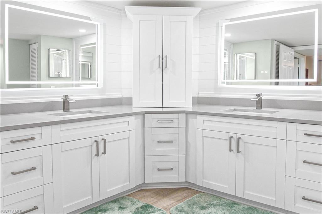 21 Bluebill Avenue, Unit B303 Naples, FL 34108 - Photo 21 of 38 a bathroom with a sink and a mirror