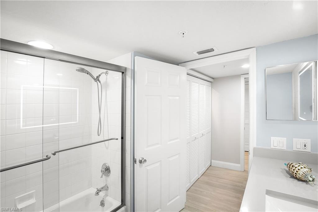 21 Bluebill Avenue, Unit B303 Naples, FL 34108 - Photo 36 of 38 a bathroom with a shower and a glass door