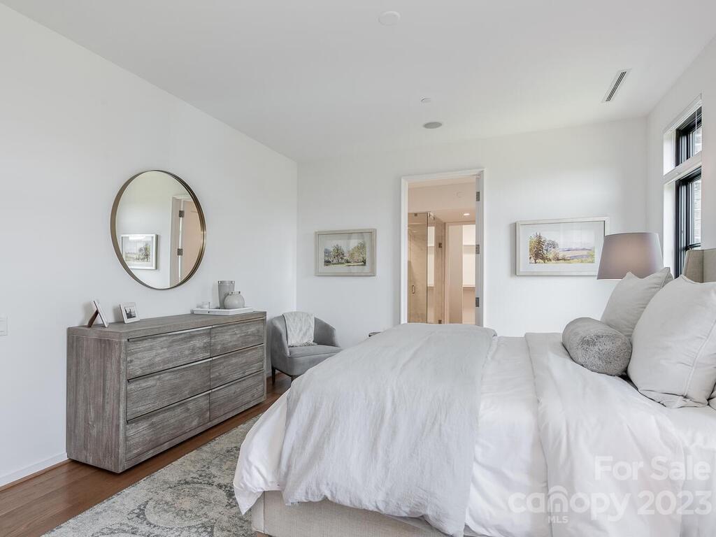 1333 Queens Road, Unit C3 Charlotte, NC 28207 - Photo 12 of 15 a bedroom with a bed a mirror and a window