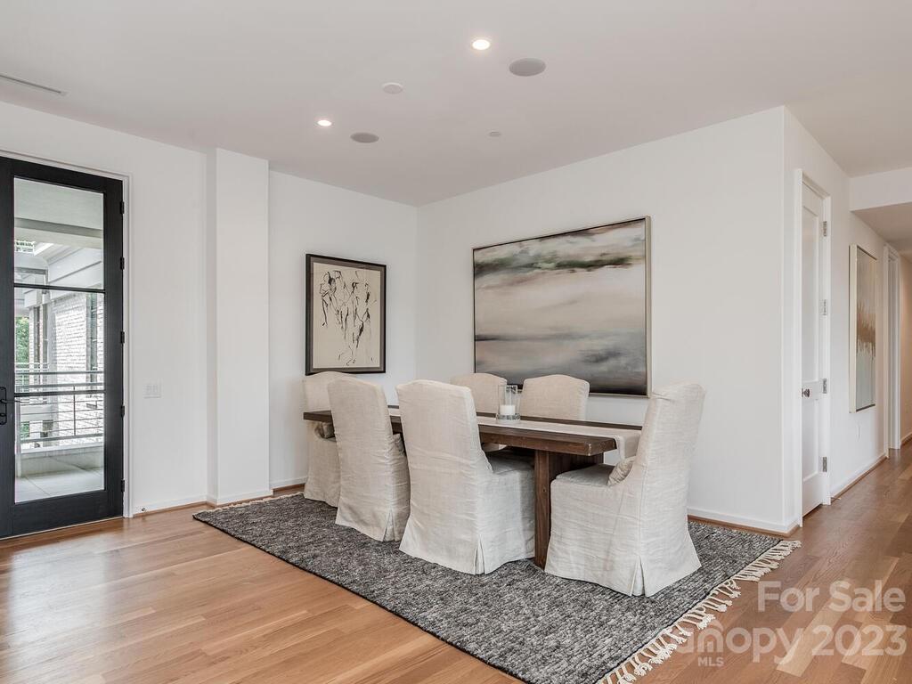 1333 Queens Road, Unit C3 Charlotte, NC 28207 - Photo 4 of 15 a living room with stainless steel appliances kitchen island granite countertop a refrigerator and a stove