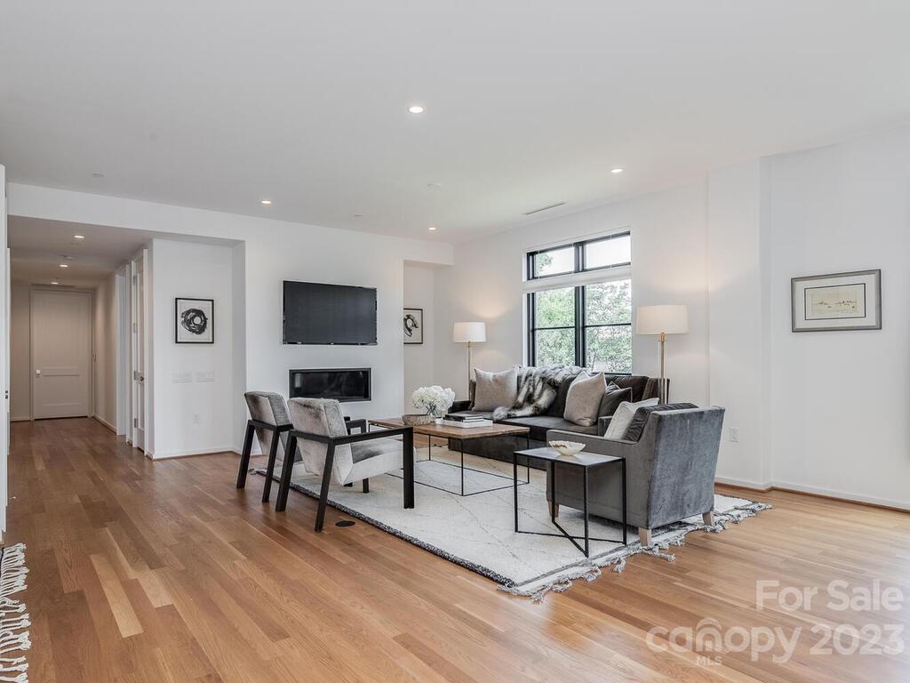 1333 Queens Road, Unit C3 Charlotte, NC 28207 - Photo 5 of 15 a living room with couches and a flat screen tv with wooden floor