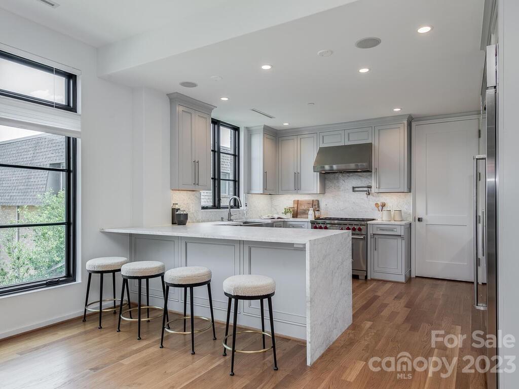 1333 Queens Road, Unit C3 Charlotte, NC 28207 - Photo 6 of 15 a kitchen with a sink cabinets and wooden floor