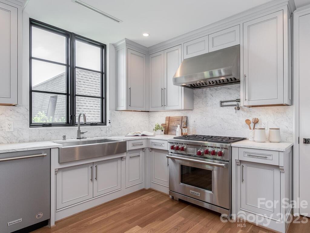 1333 Queens Road, Unit C3 Charlotte, NC 28207 - Photo 7 of 15 a kitchen with stainless steel appliances granite countertop a sink stove and cabinets