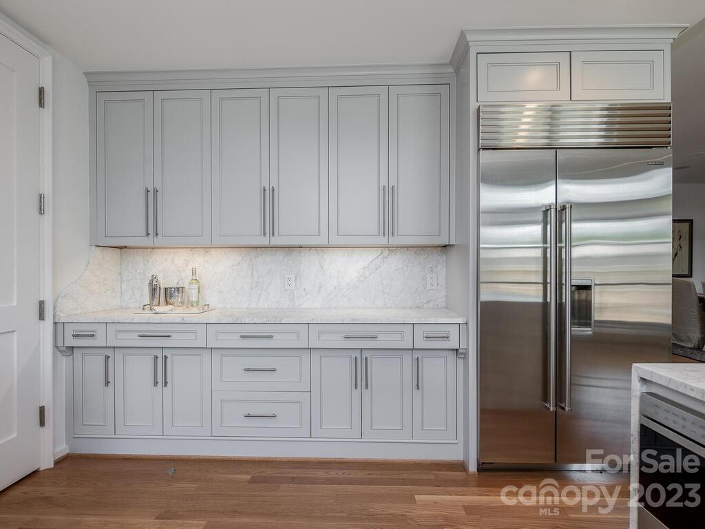 1333 Queens Road, Unit C3 Charlotte, NC 28207 - Photo 9 of 15 a kitchen with stainless steel appliances granite countertop a refrigerator and a stove top oven