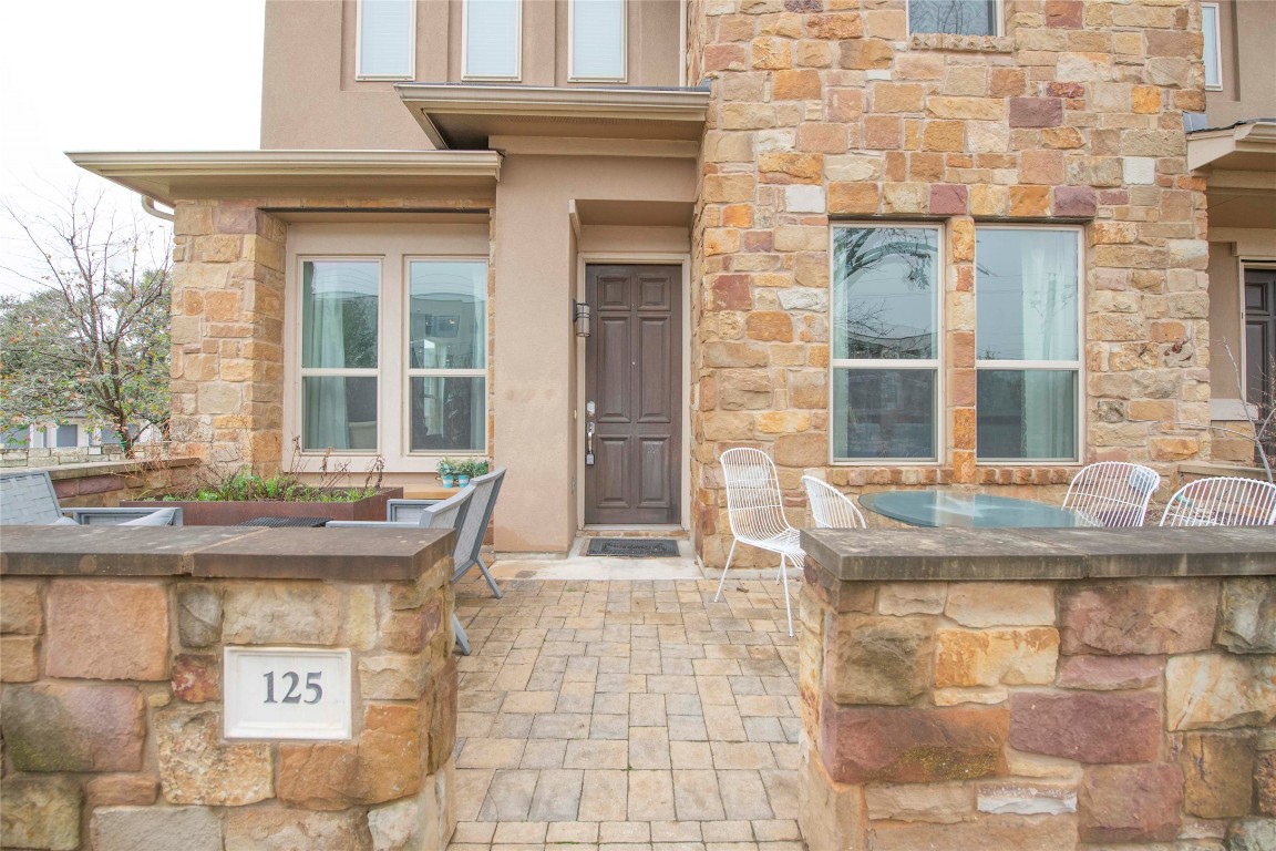 13800 Lyndhurst Street, Unit 125 Austin, TX 78717 - Photo 1 of 27 a front view of a house with outdoor seating