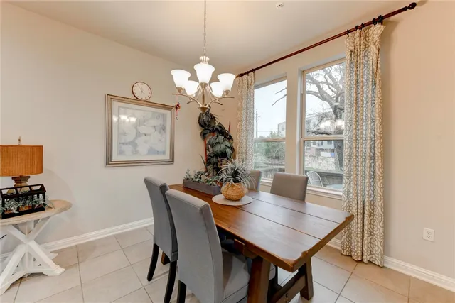 a view of a dining room with furniture wooden floor and chandelier