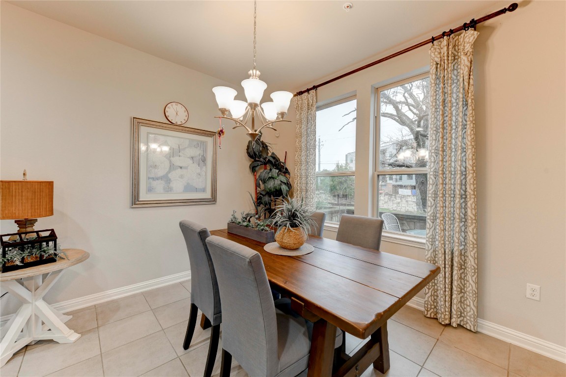 13800 Lyndhurst Street, Unit 125 Austin, TX 78717 - Photo 11 of 27 a view of a dining room with furniture wooden floor and chandelier
