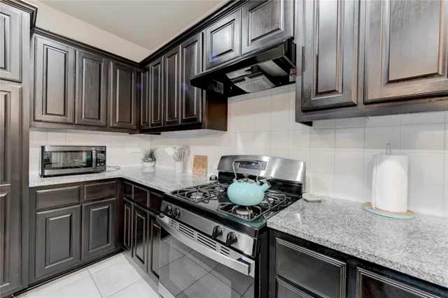 a kitchen with stainless steel appliances granite countertop a stove and a sink