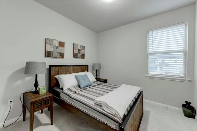 a bedroom with a bed and a desk