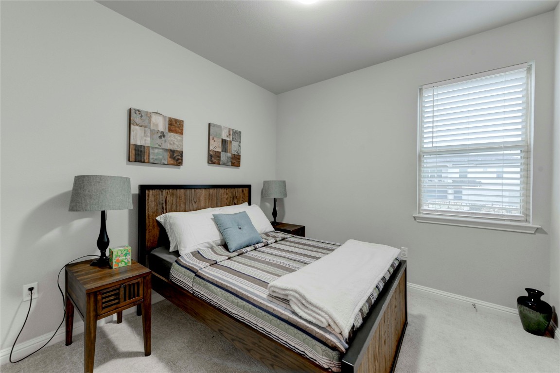 13800 Lyndhurst Street, Unit 125 Austin, TX 78717 - Photo 16 of 27 a bedroom with a bed and a desk