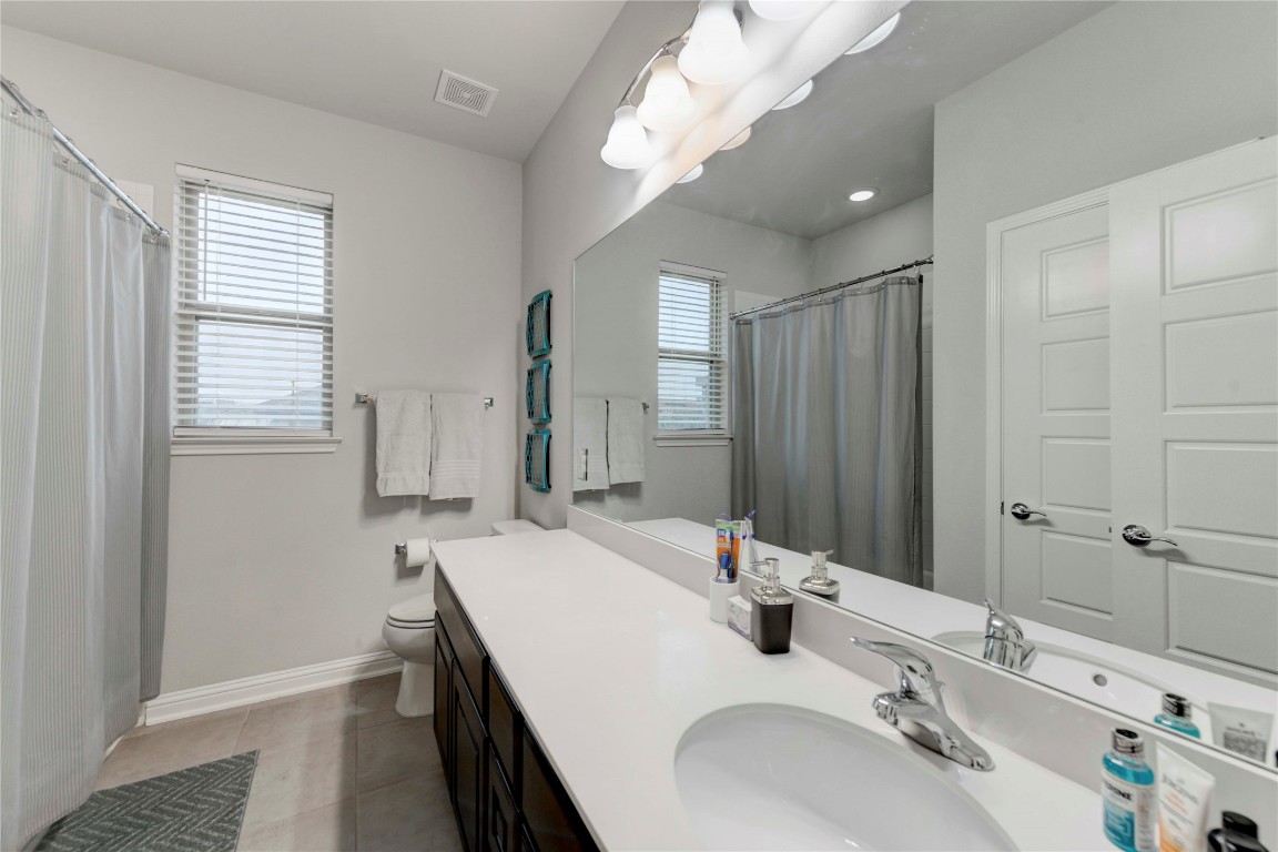 13800 Lyndhurst Street, Unit 125 Austin, TX 78717 - Photo 21 of 27 a bathroom with double vanity and a mirror